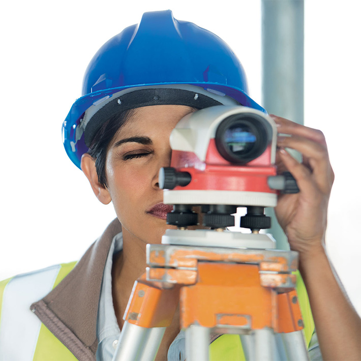 Woman surveyor wearing blue hard hat